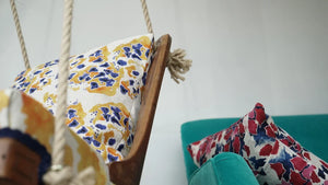Bethie Tricks Inky Linen cushion on a hanging chair