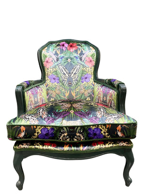 Exotica velvet by Victoria Sanders in black, jungle animals and tropical flowers upholstered on an armchair