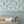 Kelp Forest wallpaper by XV Interiors in grey, kelp and seaweed behind a sofa in a living room