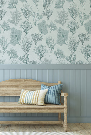 Kelp Forest wallpaper by XV Interiors in grey, kelp and seaweed behind a sofa in a living room