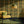 Gilded Wine wallpaper by Liberty James Studio in gold, green and red, an ornate mirrored design in a living room