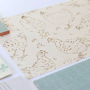 Natural Organic Hens linen by Seed Home Designs in beige, draped, showing line-drawn hens