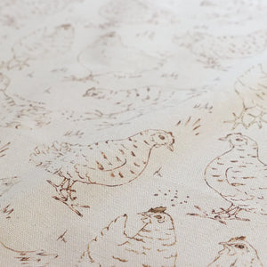 Natural Organic Hens linen by Seed Home Designs in beige, draped close-up of line-drawn hens