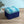 Bel Air Blossom Eco velvet by Liberty James Studio in blue, a mirrored blossom design upholstered on a fringed footstool