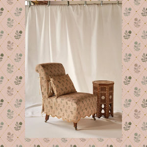 Jaipur linen by Parker and Jules in pink and green, block-print flower sprigs upholstered on an armchair
