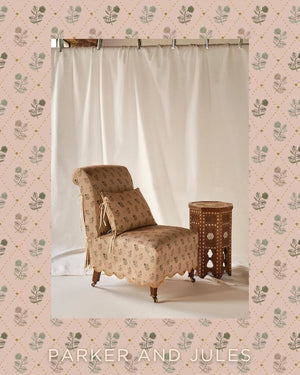 Jaipur linen by Parker and Jules in pink and green, block-print flower sprigs upholstered on an armchair