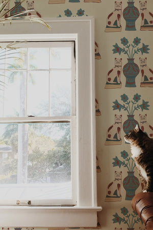 Pair of Cats wallpaper by Annika Reed in blue and cream, pairs of cats and vases in a hallway