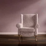 Pomegranate velvet by Annika Reed in pink, pomegranates upholstered on an armchair