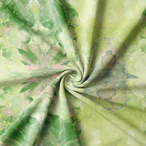 Amalfi Eco Velvet velvet by Liberty James Studio in green and pink, in soft folds showing a marbled kaleidoscope design