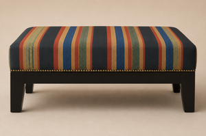 Stripe Weave linen by Dami and Em Design in terracotta, woven stripes upholstered on a fringed footstool