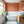 Pachamama wallpaper by Tatie Lou in coral, flying cranes on a bathroom wall