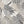 Abstract Jungle wallpaper by Brand McKenzie in grey, oversized monstera and palm leaves in a bathroom