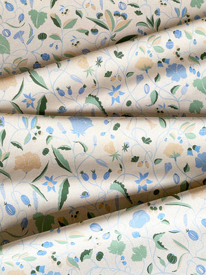 Adrienne linen by Claire de Quénetain in blue, in soft folds showing a hand-painted floral design
