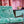 All Tomorrow’s Future linen by The Monkey Puzzle Tree in green, a dense folk-art scene upholstered on an armchair