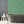 Alpine Landscape wallpaper by Brand McKenzie in green, dense alpine foliage on a bathroom wall