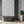 Alpine Landscape wallpaper by Brand McKenzie in grey, dense alpine foliage on a bathroom wall