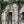 Animal Architecture wallpaper by Brand McKenzie in grey, close-up of animals peering from classical stone arches
