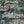 Animal Islands wallpaper by Brand McKenzie in navy, pattern detail of palm-filled islands and wildlife