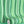 Bel Harbour wallpaper by Liberty James Studio in green, partly unrolled roll showing varied stripes