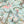 Balancing Act wallpaper by Brand McKenzie in mint green and pink, detail of monkeys, toucans and flamingos in vines