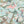 Balancing Act wallpaper by Brand McKenzie in mint green and pink, close view of monkeys, toucans and flamingos in vines