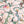 Balancing Act wallpaper by Brand McKenzie in pink, detail of monkeys, toucans and flamingos in vines