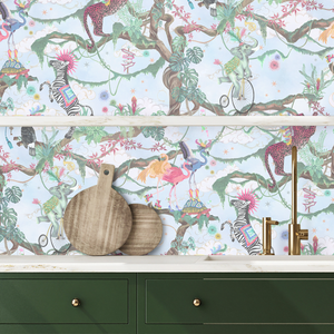 Balancing Act wallpaper by Brand McKenzie in mint green and pink behind a console table