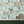 Balancing Act wallpaper by Brand McKenzie in green and blue, monkeys, toucans and flamingos in vines above a sideboard