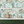 Balancing Act wallpaper by Brand McKenzie in mint green and pink above a cabinet (alternate view)