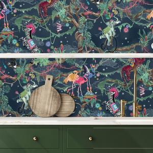 Balancing Act wallpaper by Brand McKenzie in navy, monkeys, toucans and flamingos in vines above a cabinet