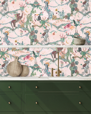 Balancing Act wallpaper by Brand McKenzie in pink, monkeys, toucans and flamingos in vines above a cabinet