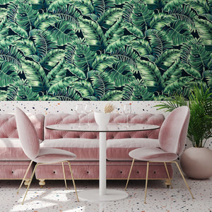Banana Leaves Max wallpaper by Brand McKenzie in green, large banana leaves on a living room wall