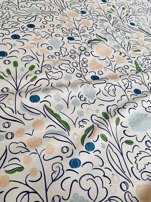 Beatrice linen by Claire de Quénetain in blue, draped, showing a hand-painted floral design