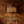 Beau Burr wallpaper by Liberty James Studio in brown and orange, a burr wood grain design in a styled room setting