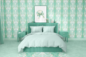 Bel Air Blossom wallpaper by Liberty James Studio in mint green, a mirrored blossom design behind a bed