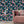Blossom Midnight wallpaper by Tatie Lou in navy, blossoms and birds behind a sofa in a living room