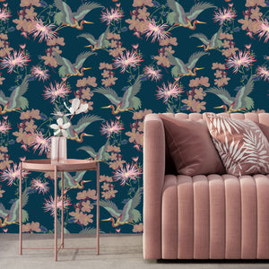 Blossom Midnight wallpaper by Tatie Lou in navy, blossoms and birds behind a sofa in a living room