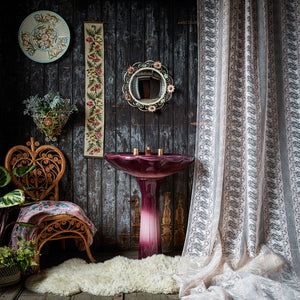 Body Lace voile fabric by The Monkey Puzzle Tree in pink, a lace body print above a sideboard