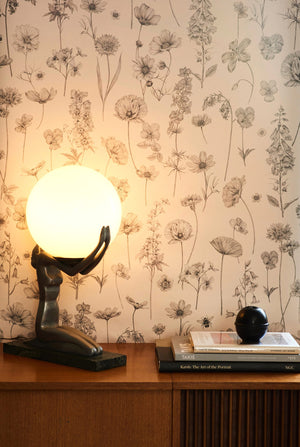 Botanica wallpaper by Victoria Sanders in green, wildflowers and poppies above a sideboard