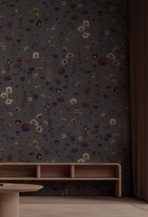 Botanica wallpaper by Victoria Sanders in dark grey, wildflowers and poppies behind a console table