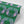 Boucle wallpaper by Tatie Lou in green, roll showing bold retro rings