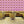 Boucle wallpaper by Tatie Lou in pink, bold retro rings in a dining area