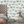 Butterfly Effect wallpaper by Brand McKenzie in green, butterflies and moths behind a bed