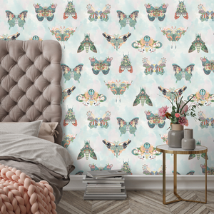 Butterfly Effect wallpaper by Brand McKenzie in green, butterflies and moths behind a bed