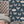 Butterfly Effect wallpaper by Brand McKenzie in navy, butterflies and moths behind a bed