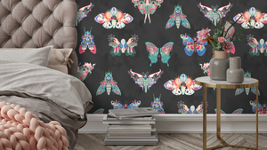 Butterfly Effect wallpaper by Brand McKenzie in black, butterflies and moths behind a bed