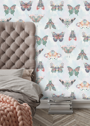 Butterfly Effect wallpaper by Brand McKenzie in white and pink, butterflies and moths behind a bed