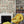 Carnival Map wallpaper by Brand McKenzie in cream, an illustrated carnival map around a fireplace