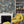 Carnival Map wallpaper by Brand McKenzie in blue, an illustrated carnival map above a white mantelpiece