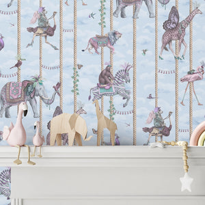 Carousel wallpaper by Brand McKenzie in blue, carousel animals on poles above a white mantelpiece